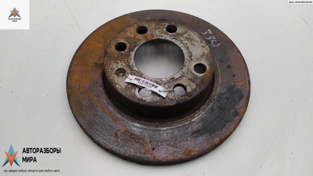 диск тормозной передний Opel Corsa B 1992, 1.4 л., бензин, АКПП, белый, хетчбэк 3 дв. - фото №1