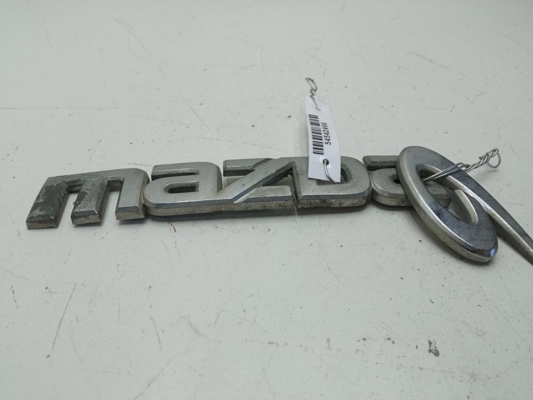 эмблема Mazda 6 GG/GY 2004, 2.3 л., бензин, МКПП, чёрный, универсал, GJ6A51711