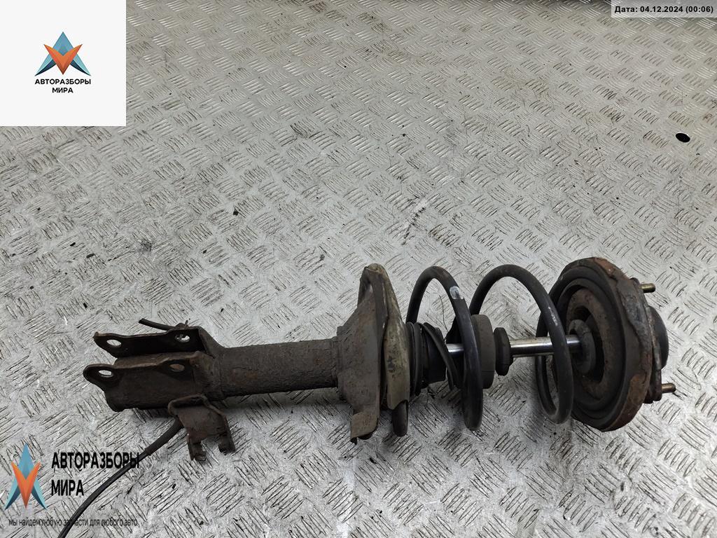 стойка передняя Nissan Almera Tino V10 2001, 1.8 л., бензин, МКПП, серый, минивэн - фото №1