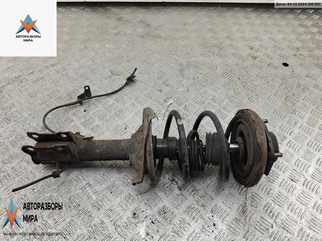 стойка передняя Nissan Almera Tino V10 2001, 1.8 л., бензин, МКПП, серый, минивэн - фото №1