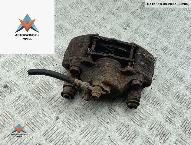 суппорт передний левый Mazda 323 BA 1997, 1.5 л., бензин, МКПП, синий, хетчбэк 5 дв. - фото №1