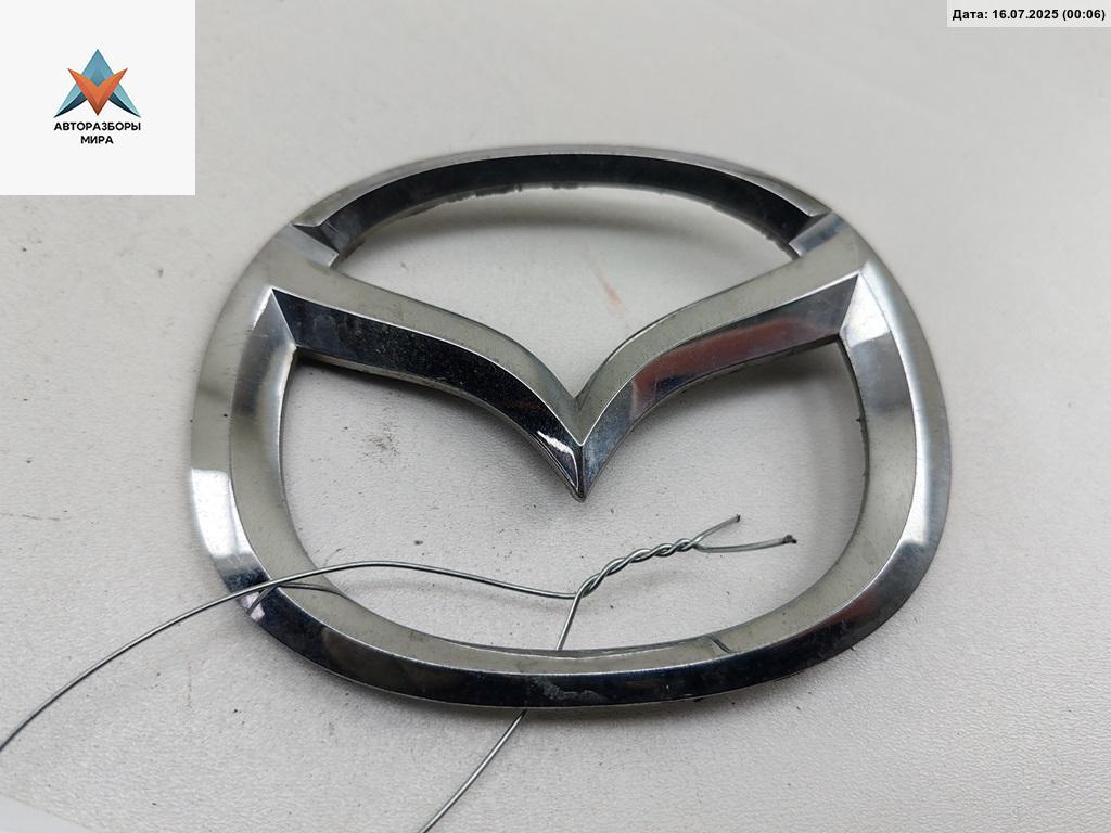 эмблема Mazda 6 GG 2002, 2.0 л., дизель, МКПП, серый, хетчбэк 5 дв., GJ6J-51730 - фото №1