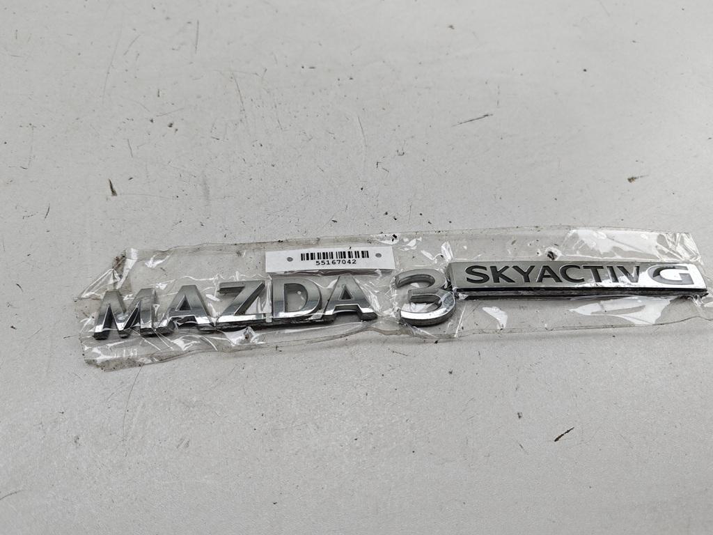 эмблема Mazda 3 Bp 2019, 2.0 л., гибрид, МКПП, чёрный, хетчбэк 5 дв.